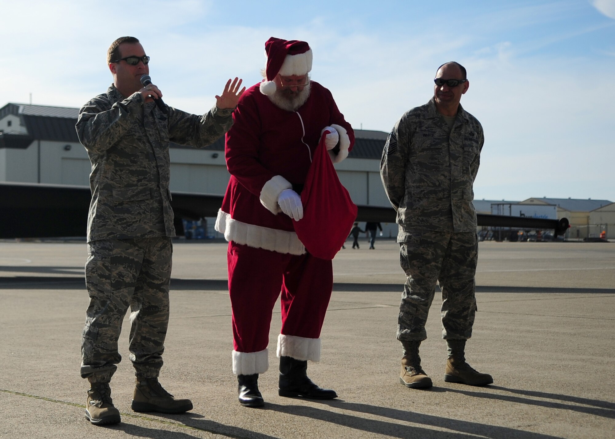 9th Reconnaissance Wing leadership introduces Santa Claus to a crowd of Airmen during the Children's Holiday Party Dec. 10 at Dock 6, Beale AFB, Calif. More than 1,500 members of Team Beale attended the holiday celebration. (U.S. Air Force photo by Senior Airman Shawn Nickel/Released)