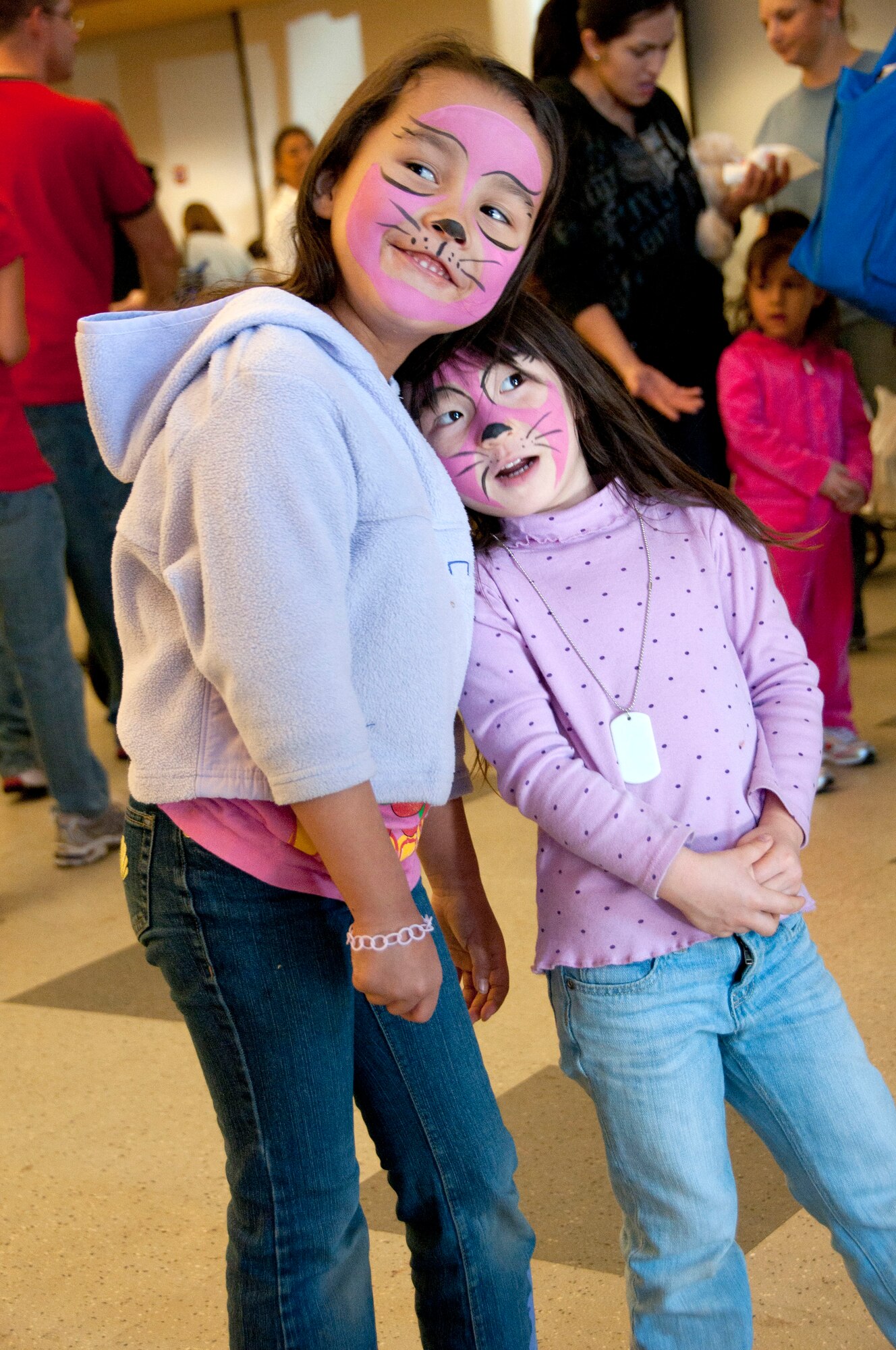 Keahilana Awana, 6, (left) daughter of Tech. Sgt. Leora Awana and Alexis Morgan, 3, daughter of Master Sgt. Dave Morgan get matching face paint at the Holiday Open House, Dec. 10, in the 162nd Fighter Wing dining facility. (U.S. Air Force photo/Master Sgt. Dave Neve)
