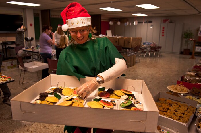 Donna O'Shaughnessy, volunteer and wife of Brig. Gen. Terrence O'Shaughnessy, 57th Wing Commander, assembles a box of cookies for the annual Cookie Drive at the base chapel Dec. 13, 2011, on Nellis Air Force Base, Nev. The Annual Cookie Drive provides homemade cookies to single Airmen living in the dormitories. (U.S. Air Force photo by Airman 1st Class George Goslin/Released)
