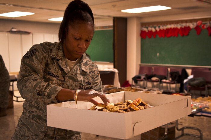 U.S. Air Force Tech. Sgt. LaNette Berard, 58th Rescue Squadron communications Non-Commissioned Officer in Charge, assembles a box of cookies for airmen for the annual Cookie Drive at the base chapel Dec. 13, 2011, at Nellis Air Force Base, Nev. The Annual Cookie Drive provides homemade cookies to single Airmen living in the dormitories. (U.S. Air Force photo by Airman 1st Class George Goslin/Released)
