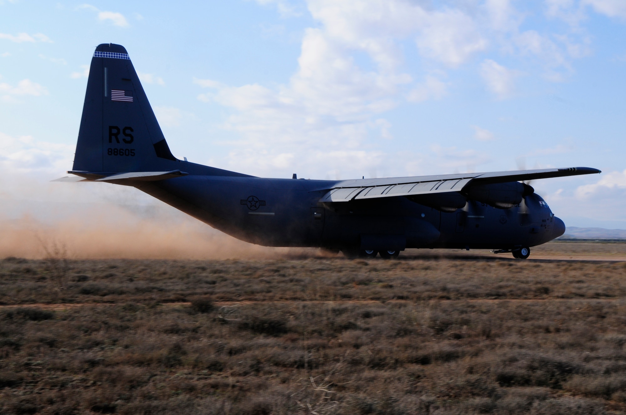 A C130J Super Hercules lands on a dirt strip at a designated landing zone during an off-site training in Zaragoza, Spain, Dec. 12, 2011. The OST consisted of a 90 member team and two aircrafts, all assembled to enhance interoperability between U.S. and Spanish Air Forces as well as build partnerships between the two countries. (U.S. Air Force photo by Senior Airman Katherine Holt)