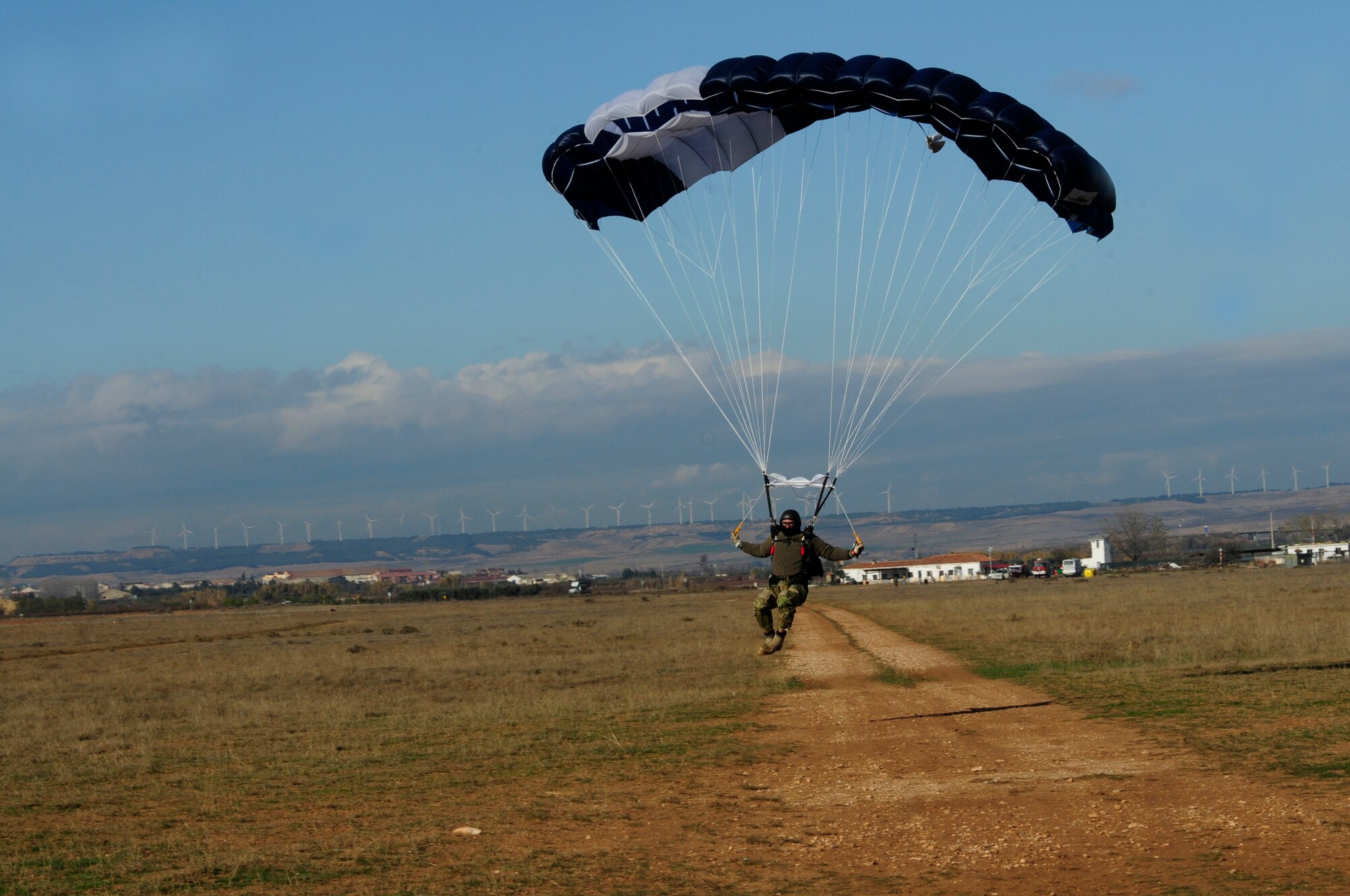 A member of the Spanish air force glides into a designated drop zone during an off-site training in Zaragoza, Spain, Dec. 12, 2011. The OST consisted of a 90 member team and two aircraft, all assembled to enhance interoperability between U.S. and Spanish air forces as well as build partnerships between the two countries. (U.S. Air Force photo by Senior Airman Katherine Holt)