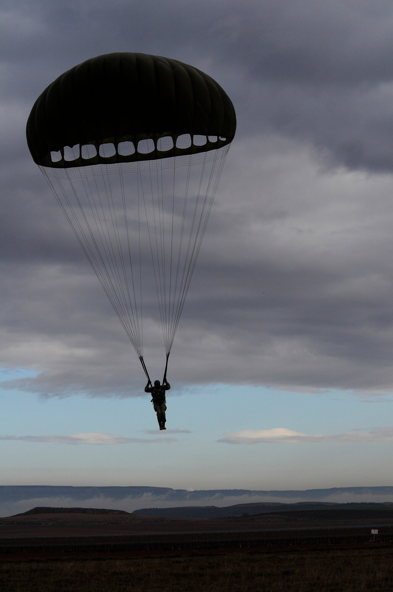 A member of the Spanish air force glides into a designated drop zone during an off-site training in Zaragoza, Spain, Dec. 12, 2011. The OST consisted of a 90 member team and two aircraft, all assembled to enhance interoperability between U.S. and Spanish air forces as well as build partnerships between the two countries. . (U.S. Air Force photo by Senior Airman Katherine Holt)