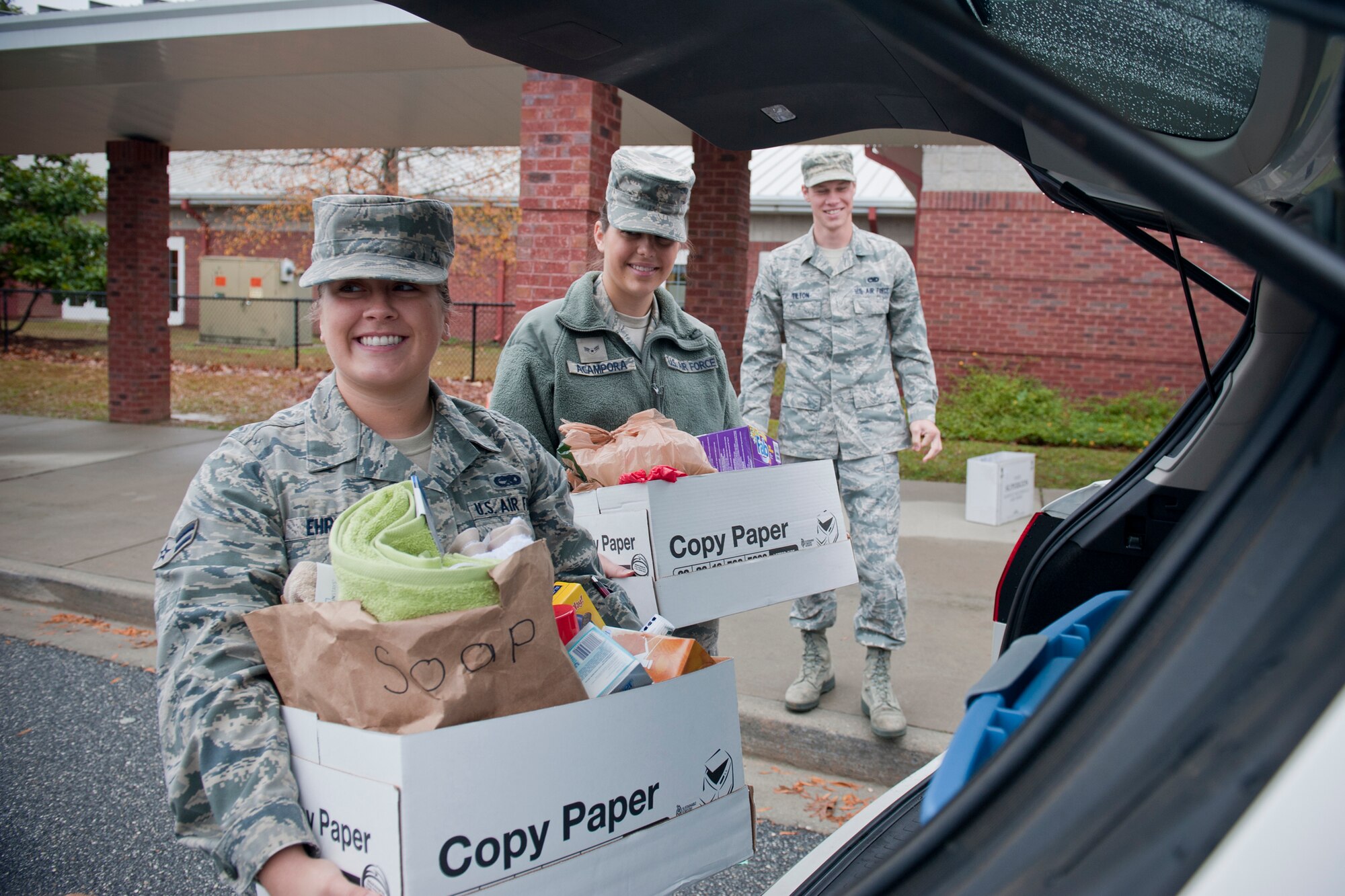 Airmen 1st Class Holly Ehrlich, 23rd Mission Operations Squadron, and Samantha Acampora, 23rd Force Support Squadron, load boxes of cookies and toiletries Dec. 12, 2011, in Hahira, Ga. The goods were donated by Valwood School in partnership with the Moody Spouses Club for the annual Moody Airmen Cookie Drive. (U.S. Air Force photo by Staff Sgt. Jamal D. Sutter/Released) 