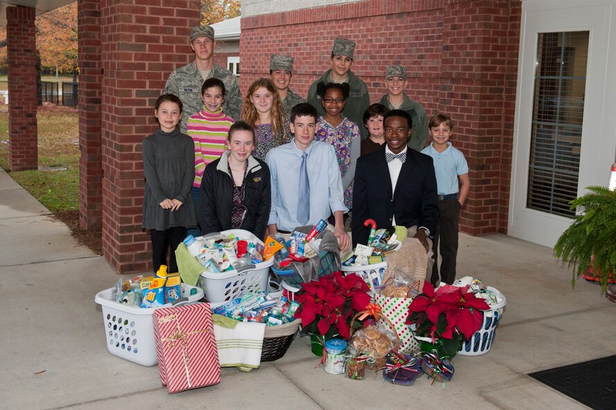Moody Airmen and Valwood School students pose for a group photo with donated cookies and toiletries Dec. 12, 2011, in Hahira, Ga., Valwood partnered with the Moody Spouses Club in support of the annual Moody Airmen Cookie Drive and collected goods for Moody’s dormitory Airmen during the holidays. (U.S. Air Force photo by Staff Sgt. Jamal D. Sutter/Released)
