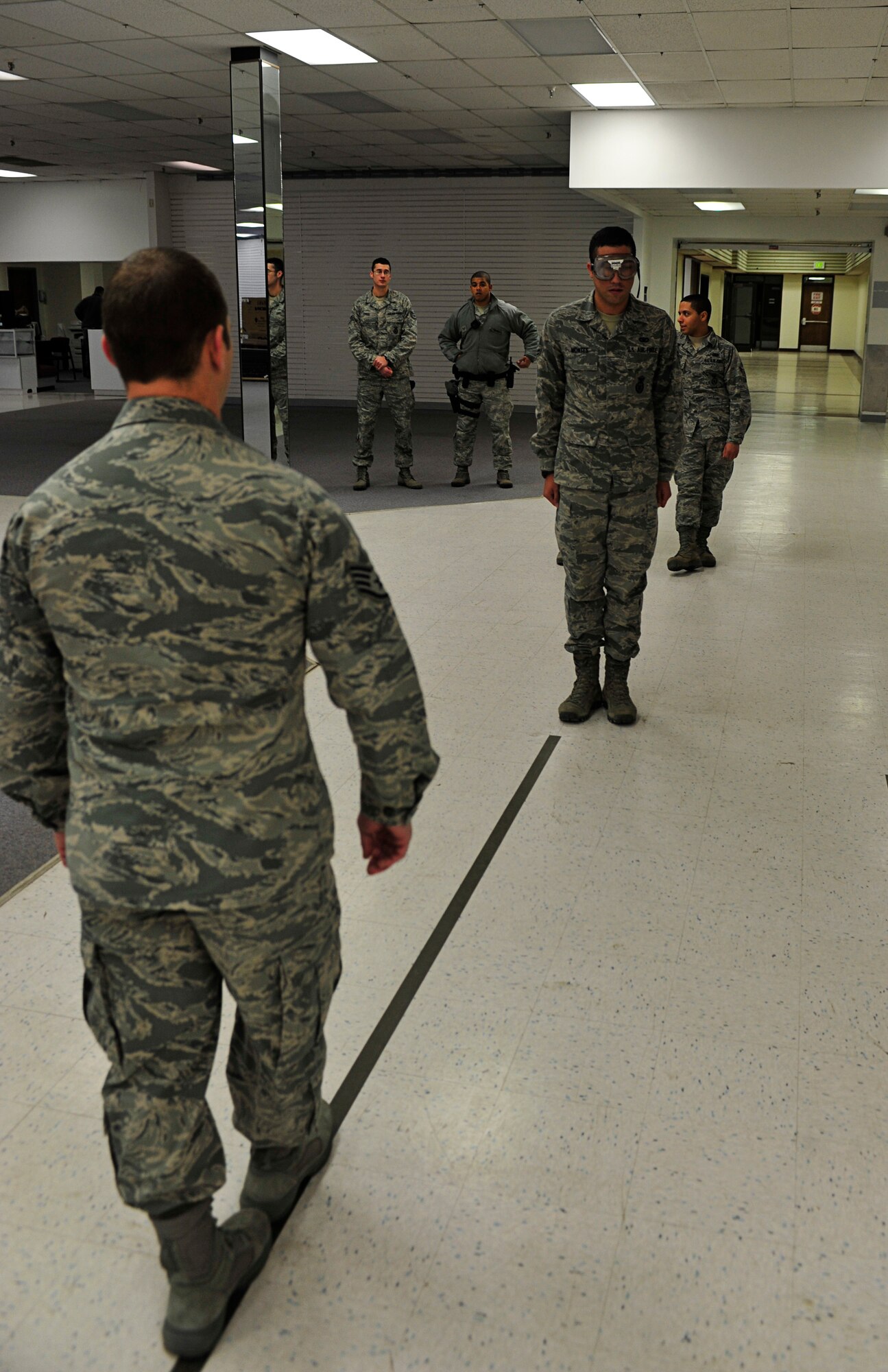 MINOT AIR FORCE BASE, N.D. -- Staff Sgt. Matthew Kline, 5th Security Forces Squadron patrolman, performs a field sobriety test on Airman 1st Class Daniel Montes, 5th SFS response force member, during a drug and drunk-driving awareness event here, Dec. 12. The event, hosted by the base Mental Health Clinic alongside other organizations, was designed to raise awareness on responsible drinking and included informative briefings on drug and alcohol abuse. (U.S. Air Force photo/Senior Airman Desiree Esposito)