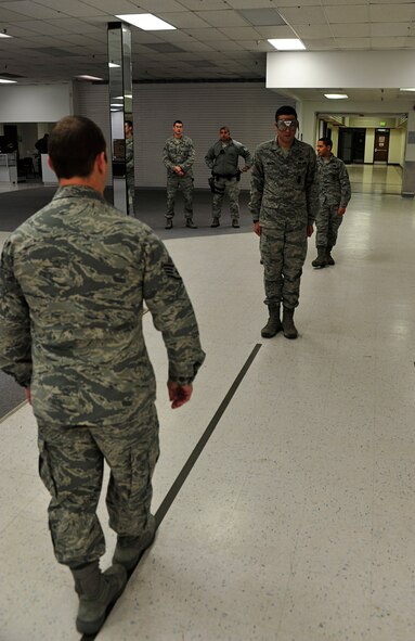 MINOT AIR FORCE BASE, N.D. -- Staff Sgt. Matthew Kline, 5th Security Forces Squadron patrolman, performs a field sobriety test on Airman 1st Class Daniel Montes, 5th SFS response force member, during a drug and drunk-driving awareness event here, Dec. 12. The event, hosted by the base Mental Health Clinic alongside other organizations, was designed to raise awareness on responsible drinking and included informative briefings on drug and alcohol abuse. (U.S. Air Force photo/Senior Airman Desiree Esposito)