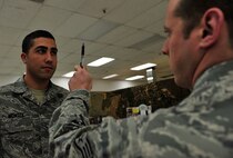 MINOT AIR FORCE BASE, N.D. -- Staff Sgt. Matthew Kline, 5th Security Forces Squadron patrolman, performs a field sobriety test on Airman 1st Class Daniel Montes, 5th SFS response force member, during a drug and drunk-driving awareness event here, Dec. 12. The event, hosted by the base Mental Health Clinic alongside other organizations, was designed to raise awareness on responsible drinking and included informative briefings on drug and alcohol abuse. (U.S. Air Force photo/Senior Airman Desiree Esposito)