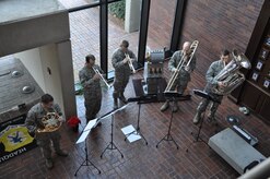 Members of the U.S. Air Force Heritage Brass Band play their instruments on tour of Joint Base Charleston - Air Base Dec. 9. The AF Heritage Band toured JB Charleston to spread holiday cheer with playing Christmas carols. For more information please visit their FB Page at http://www.facebook.com/heritageofamericaband?sk=info.(U.S. Air Force photo/Lt. Leah Davis) 

