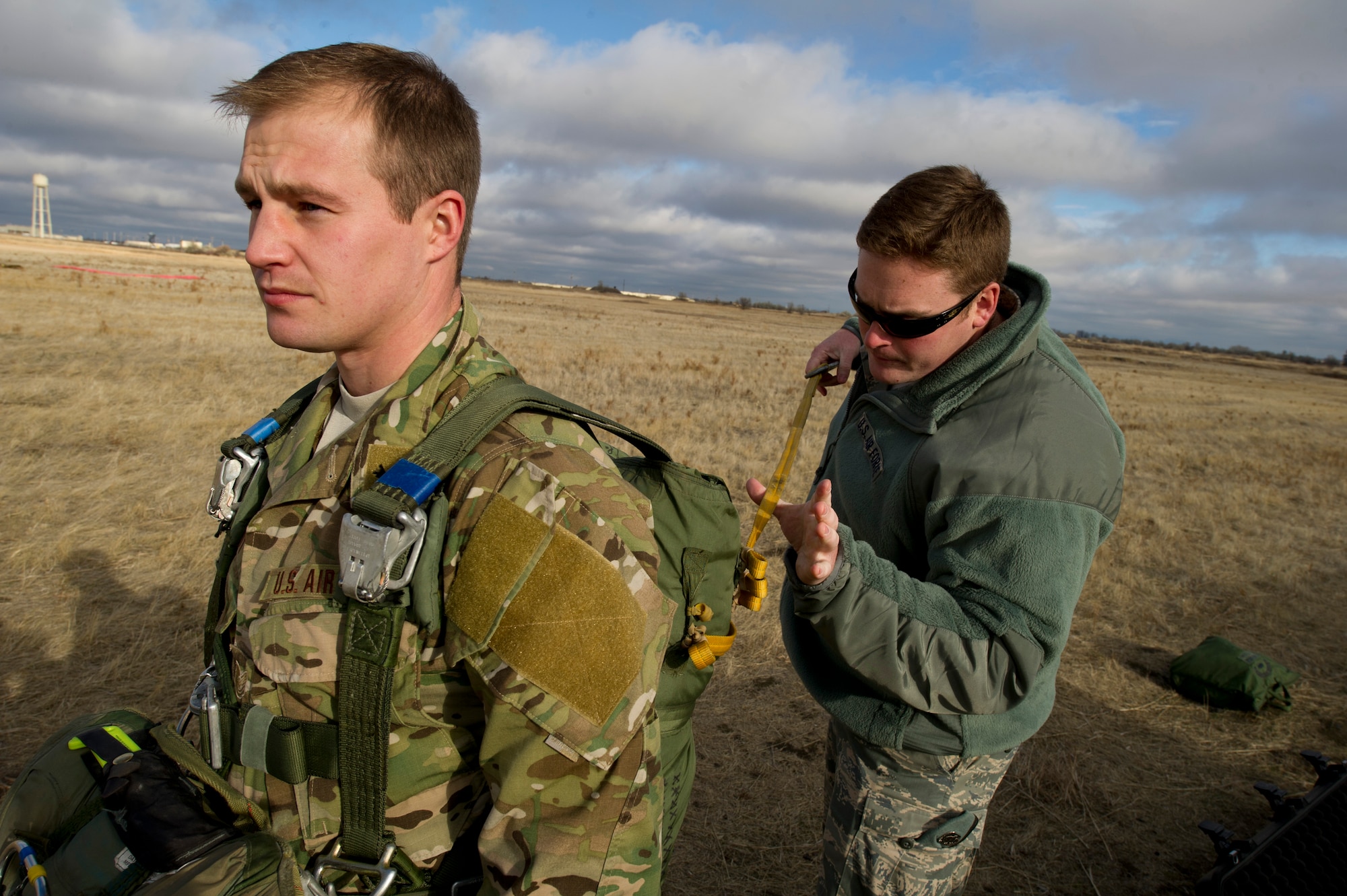 Tech. Sgt. Justin McCaffrey, SERE specialist, performs a Jump Master Personnel Inspection for Tech. Sgt. Bon Strout at their training field on Fairchild Nov. 28. “The importance of performing JMPI is to ensure all parachuting equipment works as advertised”, said Tech. Sgt. Douglas Dinger, SERE specialist. (U.S. Air Force photo/Airman 1st Class Taylor Curry)