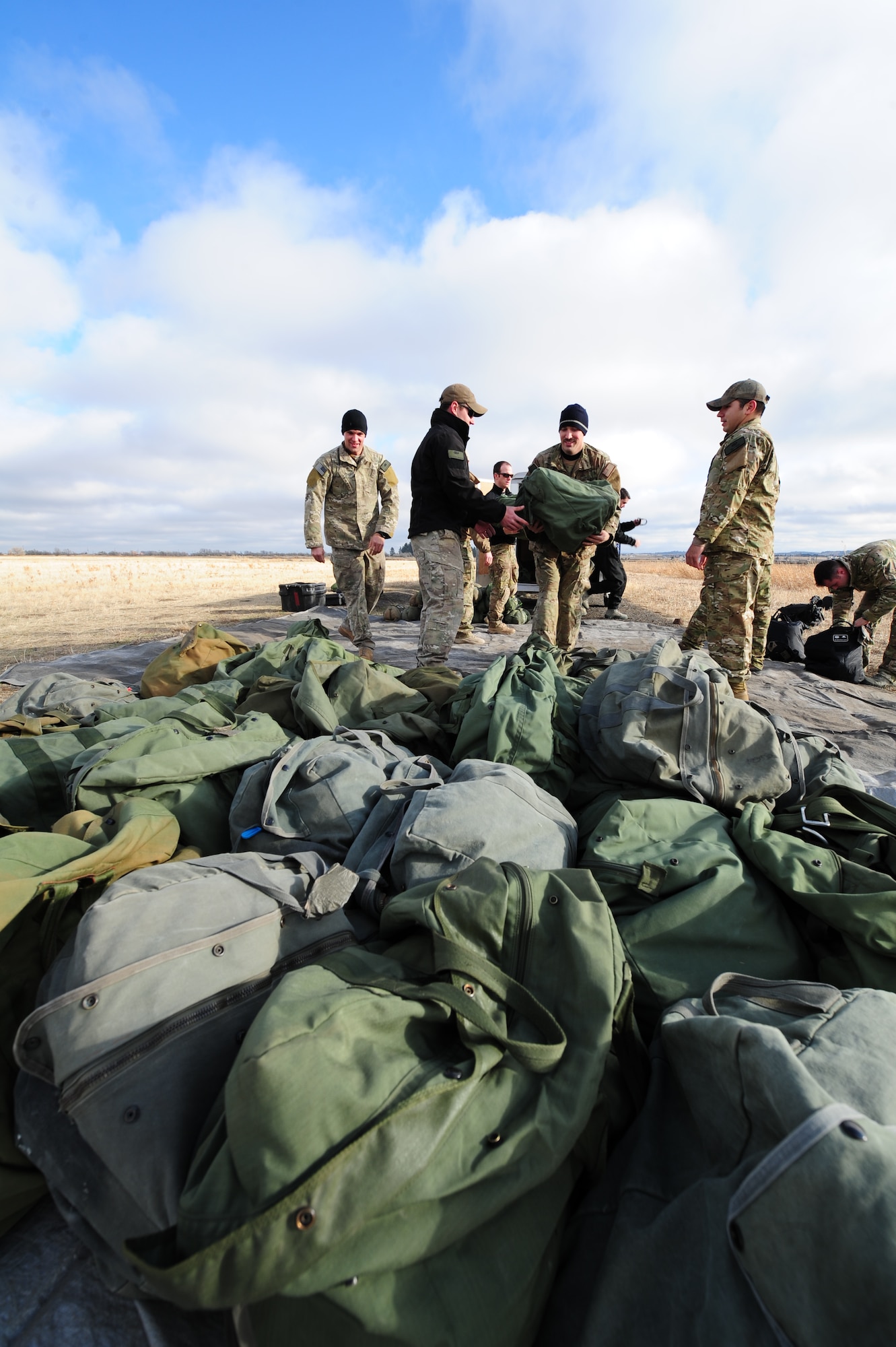 Members of the Survival, Evasion, Resistance and Escape School unload their parachute equipment at their training field on Fairchild Nov. 28. Being a SERE instructor is a specialized career field in the Air Force. They prepare DOD personnel to return from isolated events with honor. (U.S. Air Force photo/Airman 1st Class Taylor Curry)