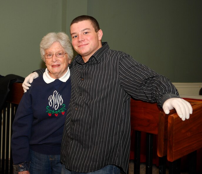 U.S. Air Force Airman 1st Class David McKenna, 20th Force Support Squadron food service specialist, and Betty Durant, retired Arts and Crafts worker, pose for a photo at the deployed families' dinner Dec. 12, 2011, Shaw Air Force Base, S.C. The dinner was held at the Carolina Skies Club and offered a free family dinner, Christmas gifts and goodies to the children .  (U.S. Air Force photo by Airman 1st Class Ashley L. Gardner/ Released)
