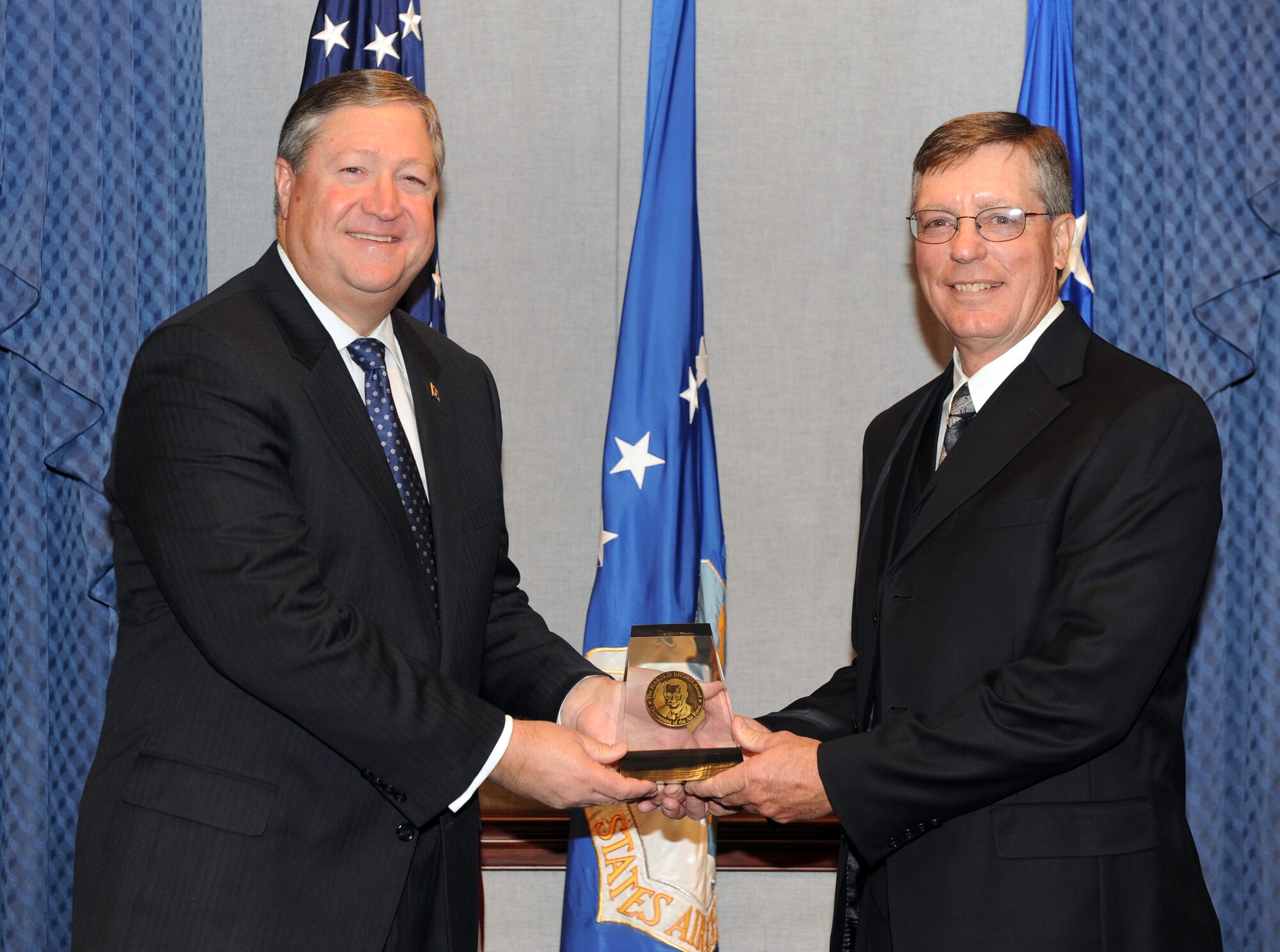 Secretary of the Air Force Michael Donley presents  the 2011 Harold Brown Award to Dr. Michael Hooser during a ceremony at the Pentagon, Washington, D.C., Dec. 12, 2011. The Harold Brown Award recognizes significant achievement in research and development that led to or demonstrated promise of a substantial improvement in operational effectiveness of the Air Force. (U.S. Air Force photo/Andy Morataya)