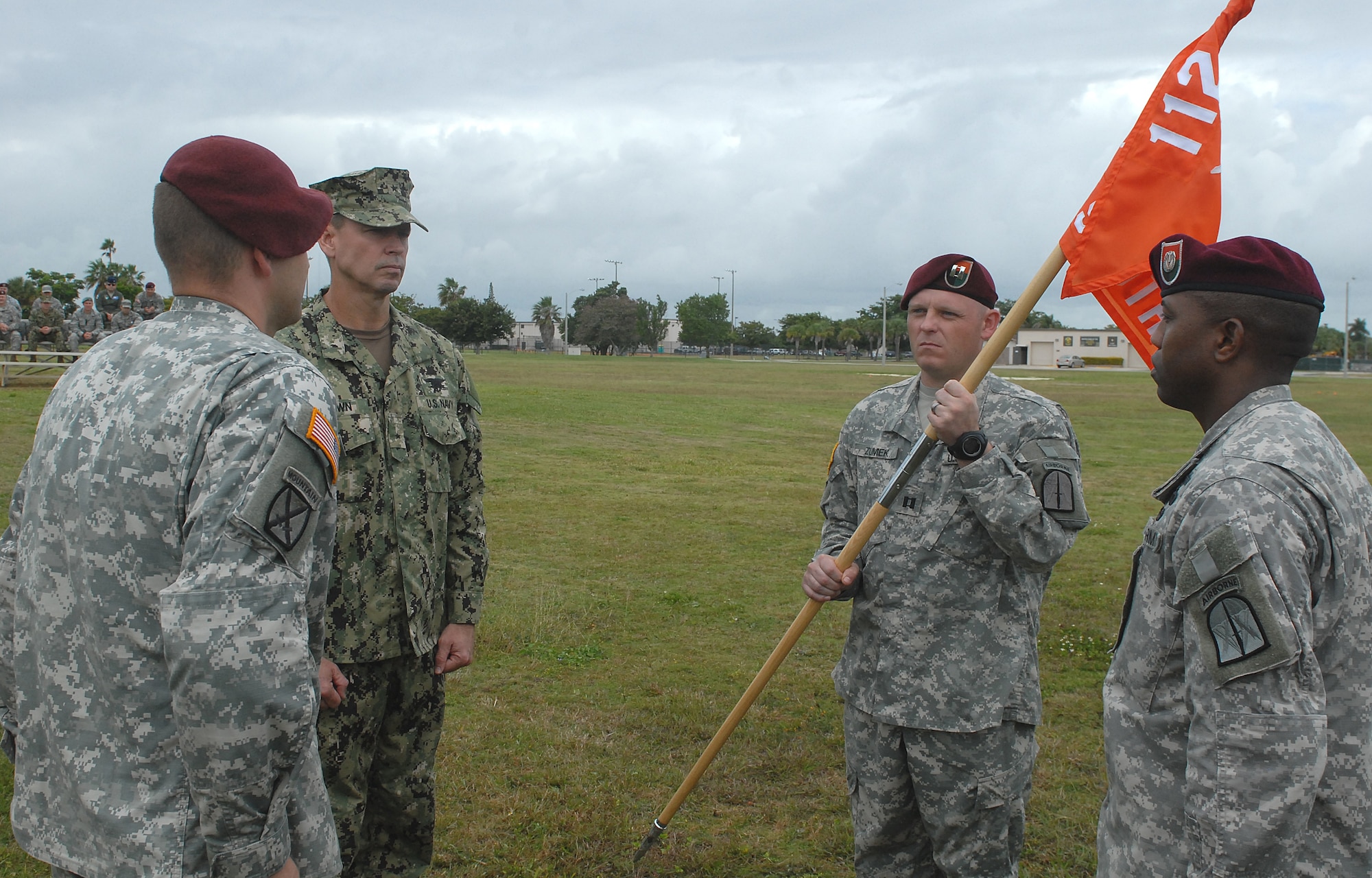 Army Capt. Jason A. Zumek (right) firmly holds the guidon of the 112th Signal Detachment during a change-of-command ceremony at Homestead Air Reserve Base, Fla., Dec. 9. The change-of-command ceremony is a formal passing of responsibility, authority and accountability of command from one leader to another.  In the Army, the change of command ceremony is conducted at all levels, from the company to the senior Army level.  (Department of Defense photo by Sgt. 1st Class Alex Licea, Special Operations Command South Public Affairs)
