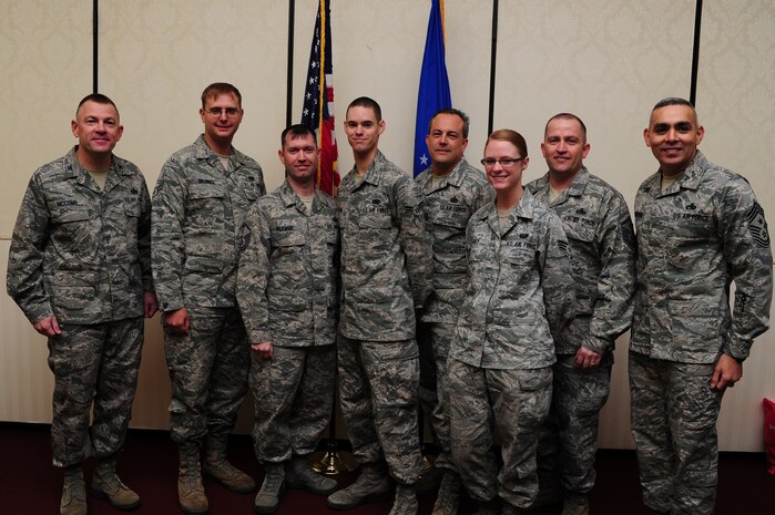 Colonel Richard McComb and Chief Master Sgt. Jose LugoSantiago recognize Airman 1st Class Anthony Brunner, Airman 1st Class Steven Stone and Senior Airman Felicia May as Diamond Sharp award winners by their respective first sergeants at the Charleston Club Dec. 13. (left to right) Col. McComb, the Joint Base Charleston commander, Airman Brunner and Master Sgt. Jeremy Klemme from the 628th Security Forces Squadron, Airman Stone and Senior Master Sgt. Jeffrey Tynan from the 628th Logistics Readiness Squadron, Senior Airman May and Master Sgt. David Turnage from the 628th Communications Squadron and Chief Master Sgt. Lugosantiago, Joint Base Charleston command chief. Diamond Sharp awardees are Airmen chosen by their first sergeants for their excellent performance.  (U.S. Air Force photo/ Staff Sgt. Nicole Mickle)  