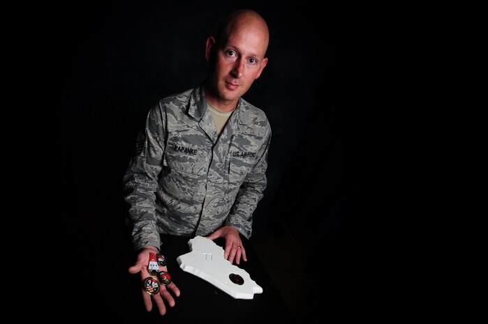 Master Sgt. Scott Kapanke  holds some of the coins and a plaque he received during his 365-day deployment with the Coalition Air Force transition team. Kapanke was diagnosed with stage four cancer in 1995 and was medically retired while he went underwent treatment. He beat the cancer and was then medically cleared to re-enlist in the Air Force in 1997. Since his return to active duty, he has taken a special duty assignment with the U.S.A.F. Thunderbirds and deployed for 365 days with the Coalition Air Force transition team to Southwest Asia to train the Iraqi Air Force on C-130 aircraft maintenance. Kapanke is with the 437th Aircraft Maintenance Squadron.
(U.S. Air Force photo/ Staff Sgt. Nicole Mickle)  
