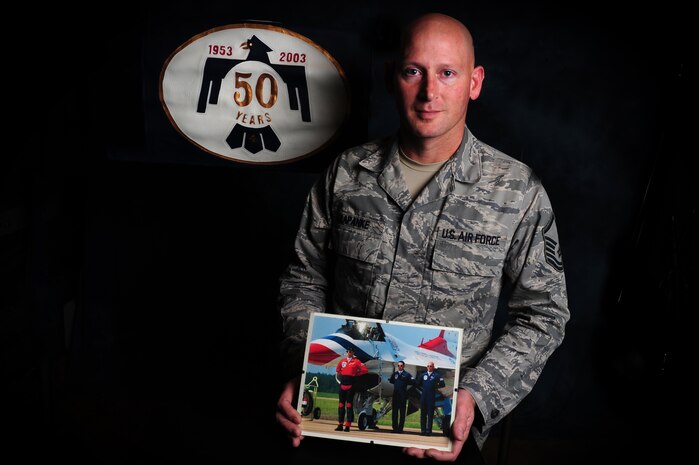 Master Sgt. Scott Kapanke displays a photograph of himself taken during his time as a crew chief with the U.S.A.F.Thunderbirds. Kapanke was diagnosed with stage four cancer in 1995 and was medically retired while he underwent treatment. He beat the cancer and was then medically cleared to re-enlist in the Air Force in 1997. Since his return to active duty, he has taken a special duty assignment with the U.S.A.F. Thunderbirds and deployed for 365 days with the Coalition Air Force transition team to Southwest Asia to train the Iraqi Air Force on C-130 aircraft maintenance. Kapanke is with the 437th Aircraft Maintenance Squadron.  (U.S. Air Force photo/ Staff Sgt.
Nicole Mickle)  
