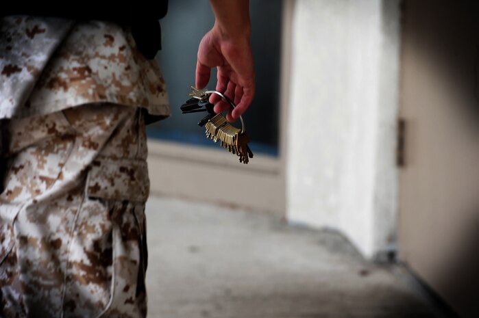 Marine Sergeant Xavier Reyes walks to one of the new housing units inside the Naval Consolidated Brig Charleston at Joint Base Charleston - Weapons Station Sept. 14. The new 24,000 square foot housing unit can accommodate 80 additional prisoners. Reyes is a prison guard at the NAVCONBRIG. (U.S. Air Force photo/ Staff Sgt. Nicole Mickle) 