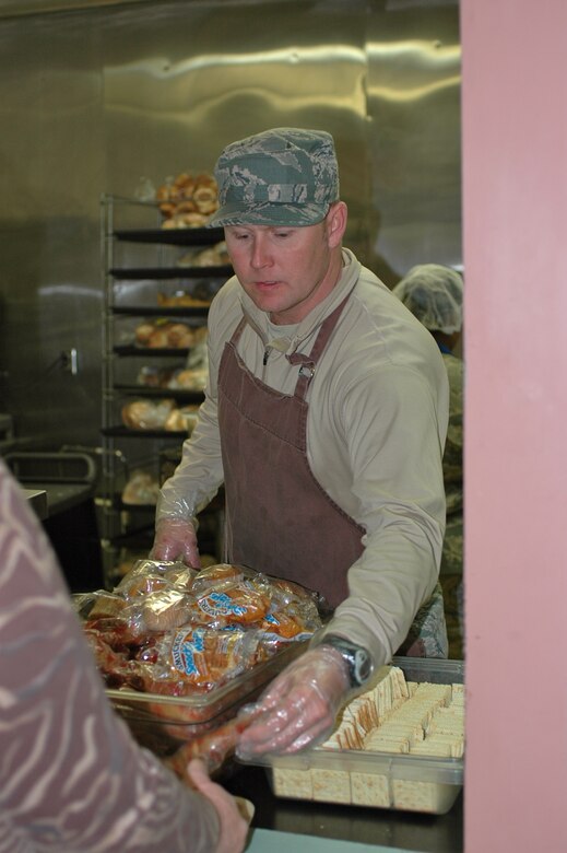 Master Sgt. Ricky Harmon, one of 10 volunteers from the 388th Fighter Wing, serves lunch Dec. 6 to nearly 100 homeless guests of St. Anne’s Center, located in Ogden, Utah. (U.S. Air Force photo/Andrea Mason)