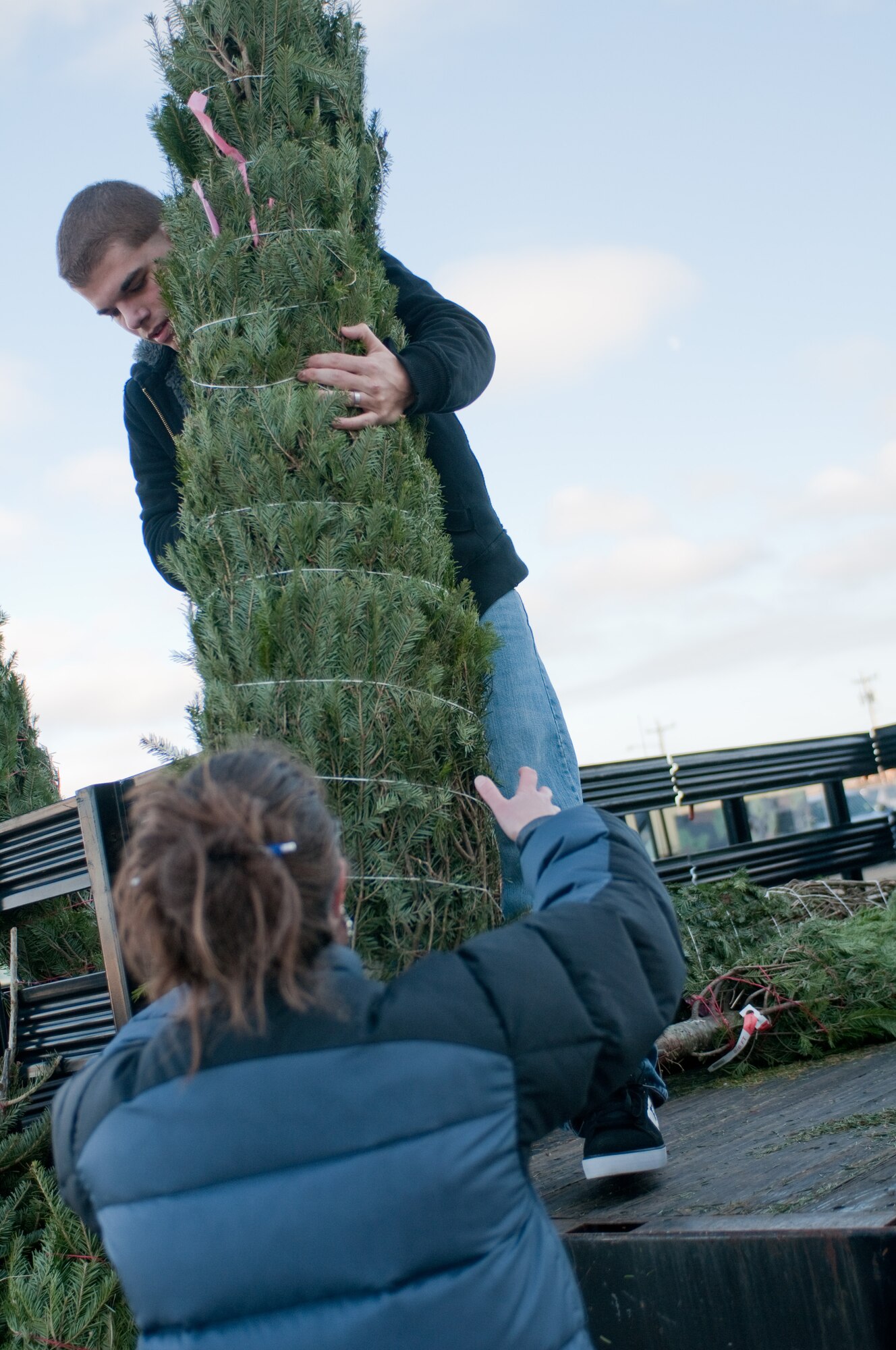 Airman First Class Michael Servis of the 102nd Intelligence Wing receives a Christmas tree donated by the Mt. Horeb Masonic Lodge from Dennis, Massachusetts. A total 11 trees were donated to the 102nd on December 4, 2011. (National Guard photo by Senior Airman Jeremy Bowcock/Released)