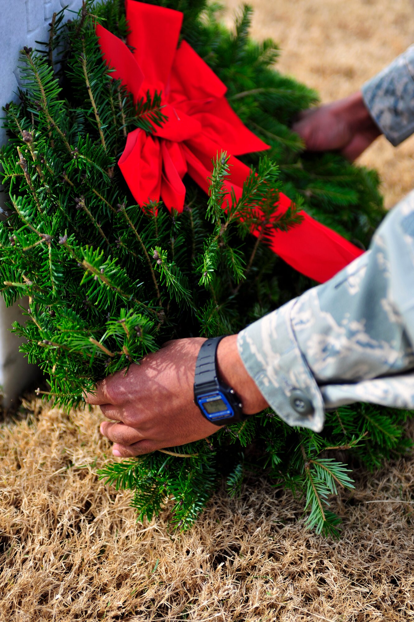 A U.S. Air Force Airman places a wreath on a gravestone at the Wreaths Across America ceremony at Fort Jackson National Cemetery, Columbia, S.C., Dec. 10, 2011. Wreaths Across America occurs the second Saturday of December every year. People gather to lay holiday wreaths on the gravestones at national military cemeteries. (U.S. Air Force photo/Senior Airman Daniel Phelps/Released)