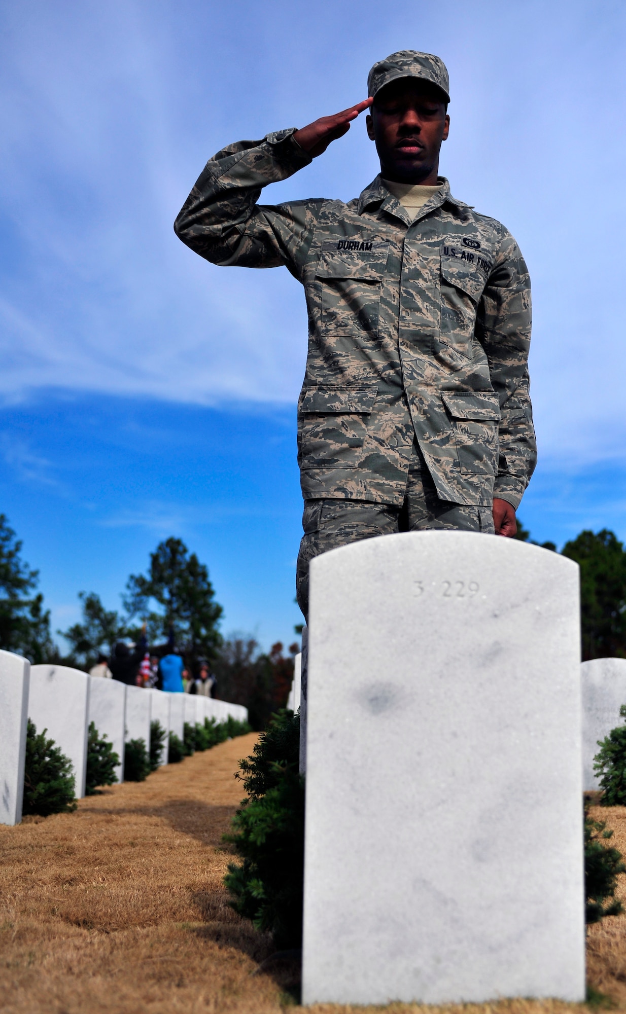 U.S. Air Force Airman 1st Class Jaren Durham, 28th Operational Weather Squadron, salutes the gravestone of a servicemember at the Wreaths Across America ceremony at Fort Jackson National Cemetery, Columbia, S.C., Dec. 10, 2011. Wreaths Across America occurs the second Saturday of December every year. People gather to lay holiday wreaths on the gravestones at national military cemeteries. (U.S. Air Force photo/Senior Airman Daniel Phelps/Released)