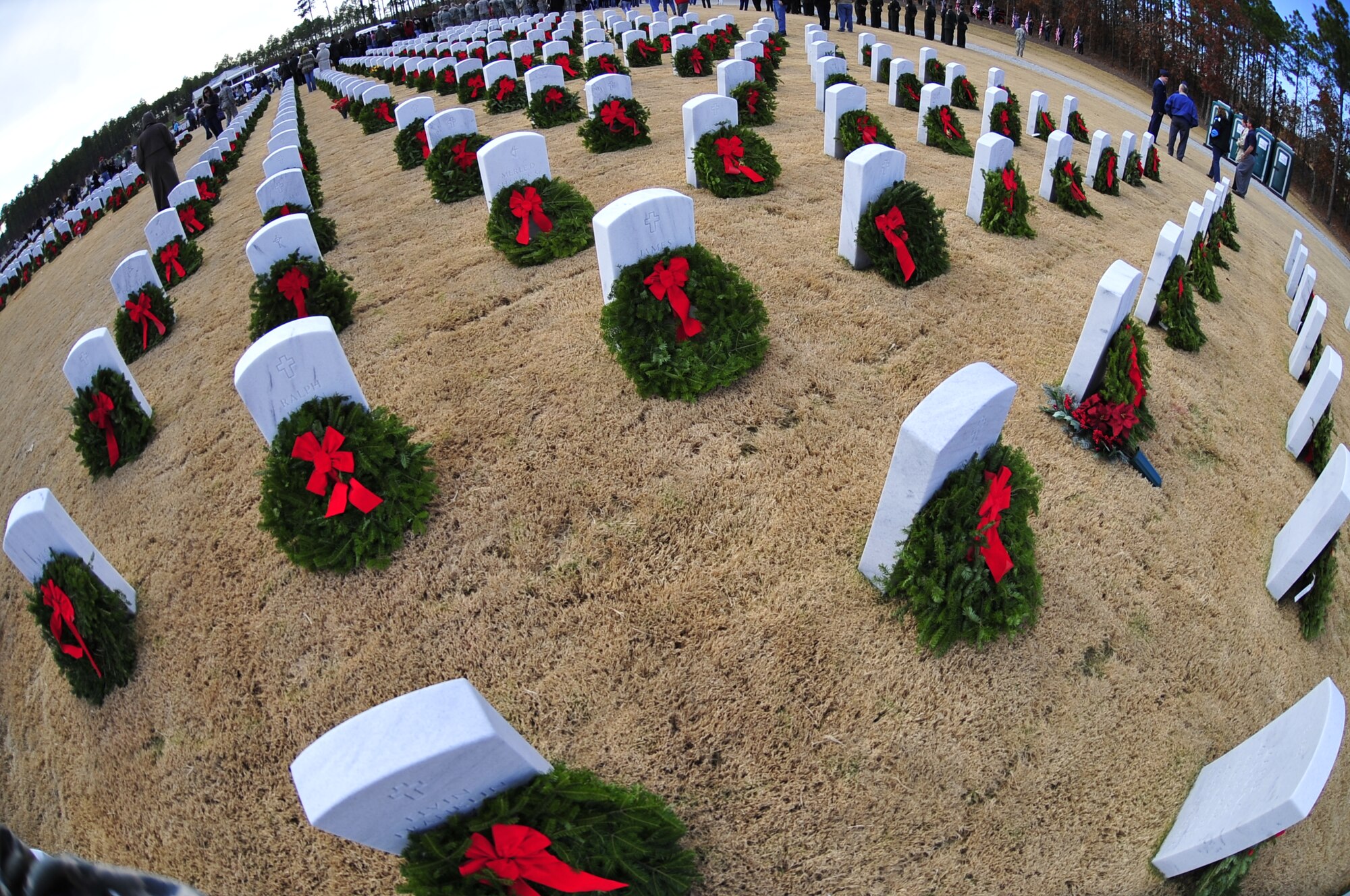 Holiday wreaths lie on the gravestones of America’s heroes at the Wreaths Across America ceremony at Fort Jackson National Cemetery, Columbia, S.C., Dec. 10, 2011. Wreaths Across America occurs the second Saturday of December every year. People gather to lay holiday wreaths on the gravestones at national military cemeteries. (U.S. Air Force photo/Senior Airman Daniel Phelps/Released)