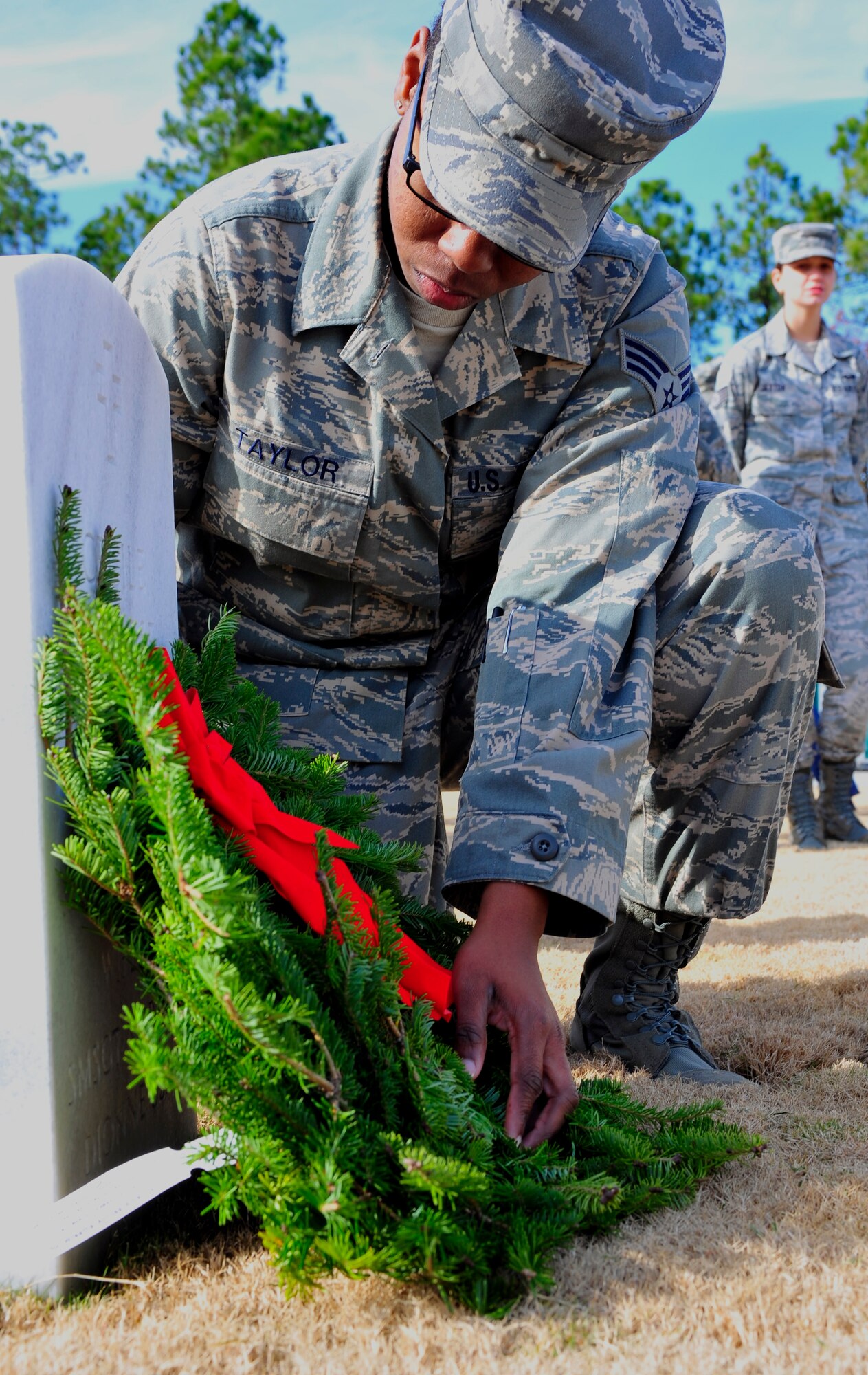 U.S. Air Force Senior Airman Amanda Taylor, 20th Force Support Squadron force management, lays a wreath on a gravestone at the Wreaths Across America ceremony at Fort Jackson National Cemetery, Columbia, S.C., Dec. 10, 2011. Wreaths Across America occurs the second Saturday of December every year. People gather to lay holiday wreaths on the gravestones at national military cemeteries. (U.S. Air Force photo/Senior Airman Daniel Phelps/Released)