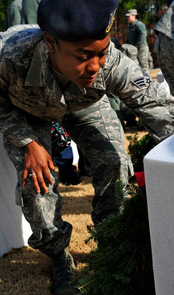 U.S. Air Force Senior Airman Patricia Folkes, 20th Security Forces Squadron, lays a wreath on a gravestone at the Wreaths Across America ceremony at Fort Jackson National Cemetery, Columbia, S.C., Dec. 10, 2011. Wreaths Across America occurs the second Saturday of December every year. People gather to lay holiday wreaths on the gravestones at national military cemeteries. (U.S. Air Force photo/Senior Airman Daniel Phelps/Released)