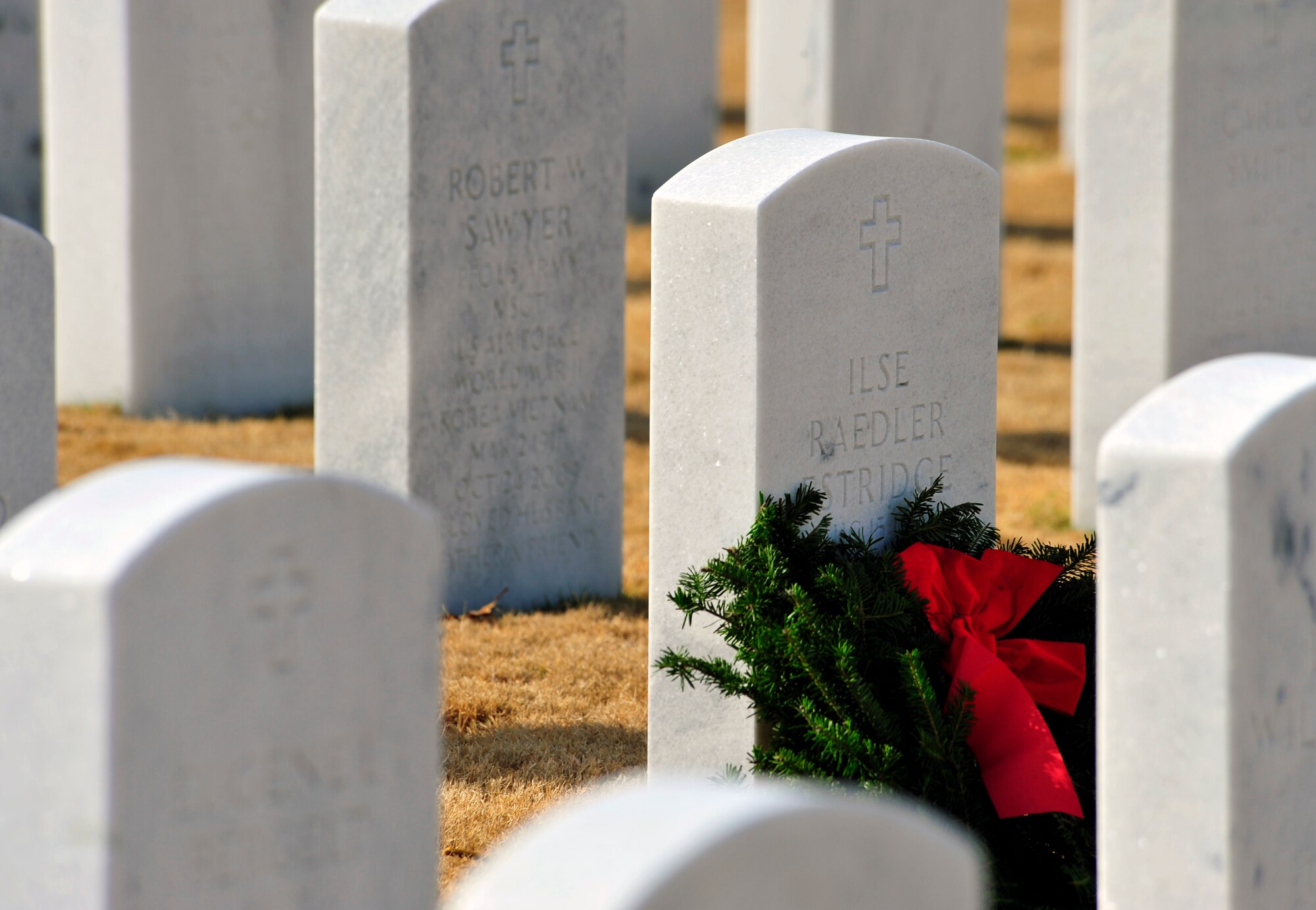 A holiday wreath lies on the gravestone of a servicemember at the Wreaths Across America ceremony at Fort Jackson National Cemetery, Columbia, S.C., Dec. 10, 2011. Wreaths Across America occurs the second Saturday of December every year. People gather to lay holiday wreaths on the gravestones at national military cemeteries. (U.S. Air Force photo/Senior Airman Daniel Phelps/Released)