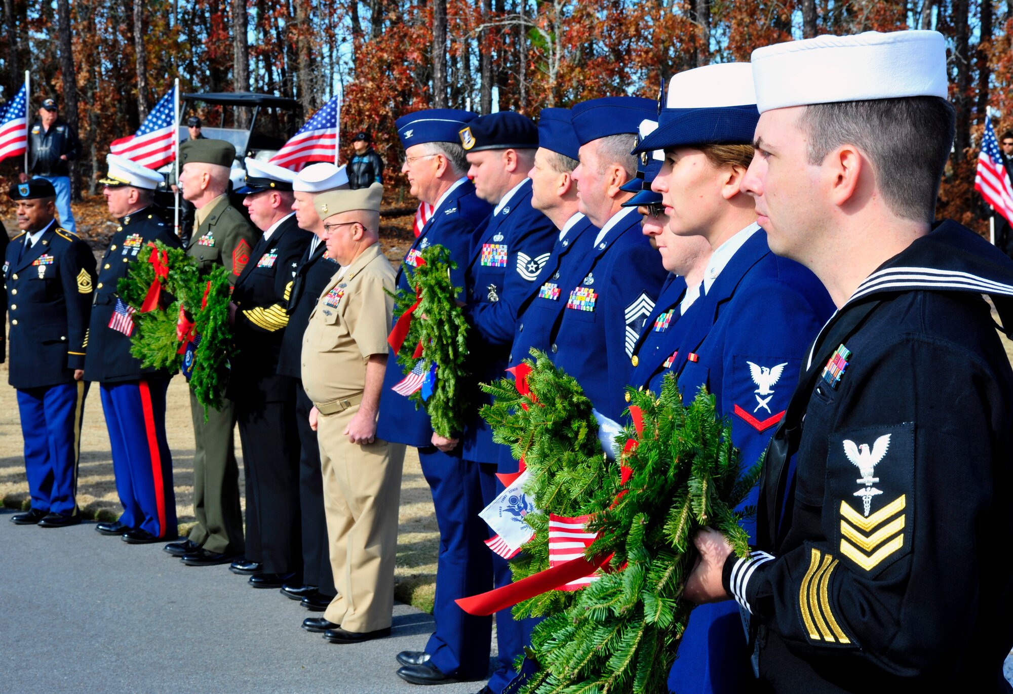 Past and present servicemembers from all branches stand ready to lay wreaths at the memorials of their services during the Wreaths Across America ceremony at Fort Jackson National Cemetery in Columbia, S.C., Dec. 10, 2011. Wreaths Across America occurs the second Saturday of December every year. People gather to lay holiday wreaths on the gravestones at national military cemeteries. (U.S. Air Force photo/Senior Airman Daniel Phelps/Released)