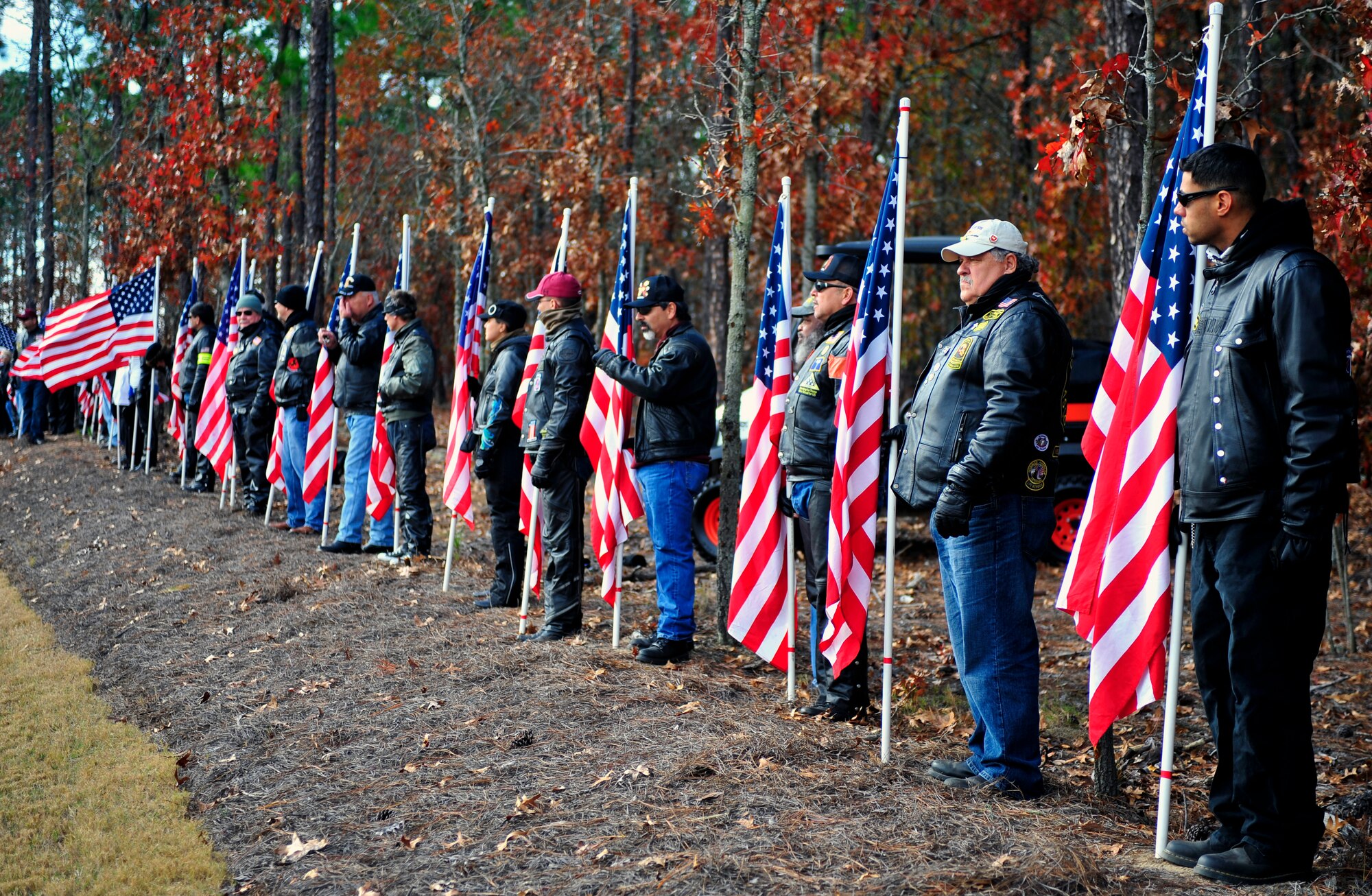 Patriot Guard Riders hold American flags in a during the Wreaths Across America ceremony at Fort Jackson National Cemetery, Columbia, S.C., Dec. 10, 2011. Wreaths Across America occurs the second Saturday of December every year. People gather to lay holiday wreaths on the gravestones at national military cemeteries. (U.S. Air Force photo/Senior Airman Daniel Phelps/Released)