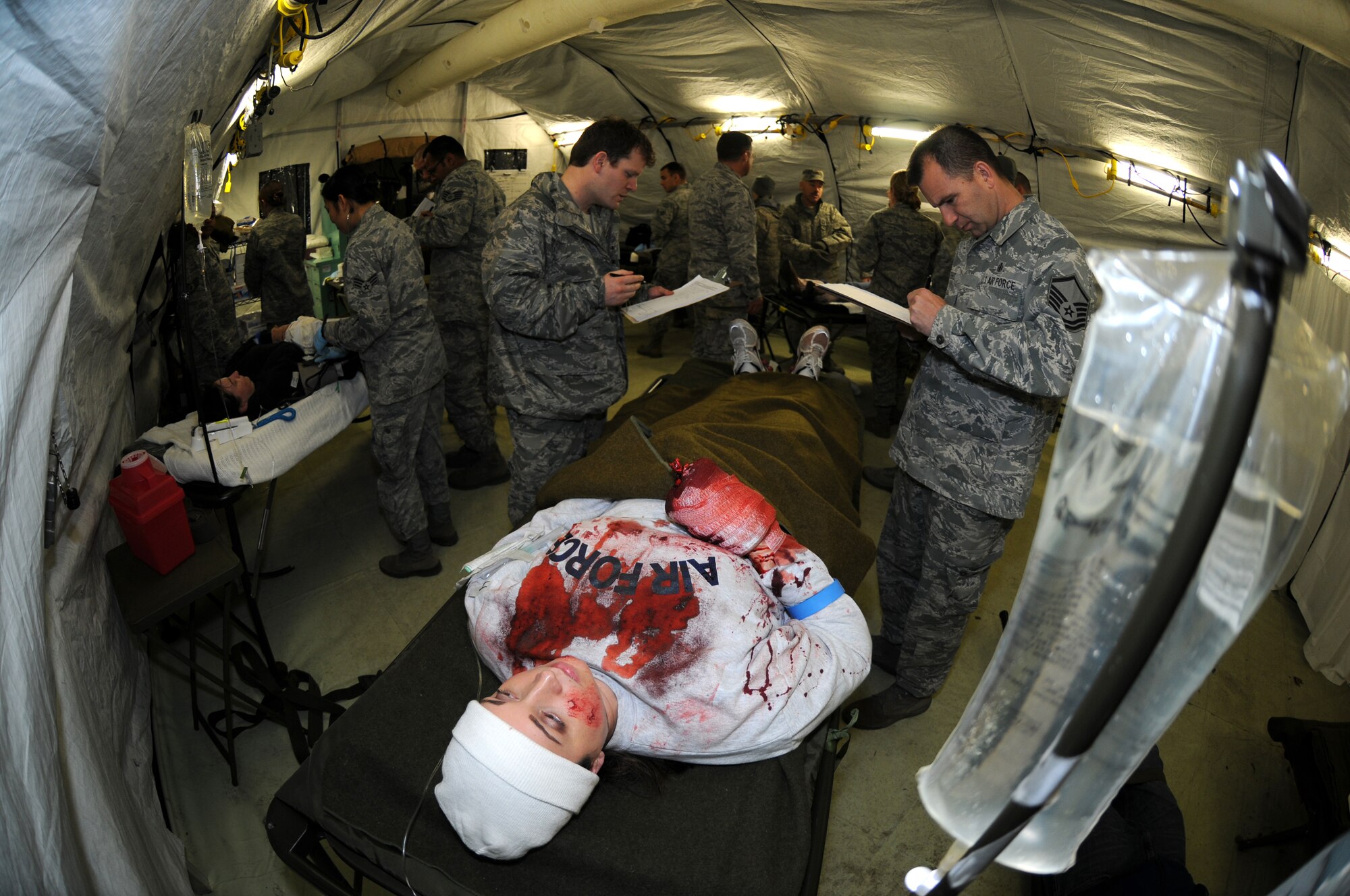 ROYAL AIR FORCE FELTWELL, England – The 48th Medical Group treat a victim of a mass casualty exercise, Dec. 8, 2011. The 48th MDG hosted a week-long mobile Expeditionary Medical Support course at RAF Feltwell to keep their readiness capabilities sharp in a mock-deployed environment. (U.S. Air Force photo by Airman 1st Class Cory D. Payne)