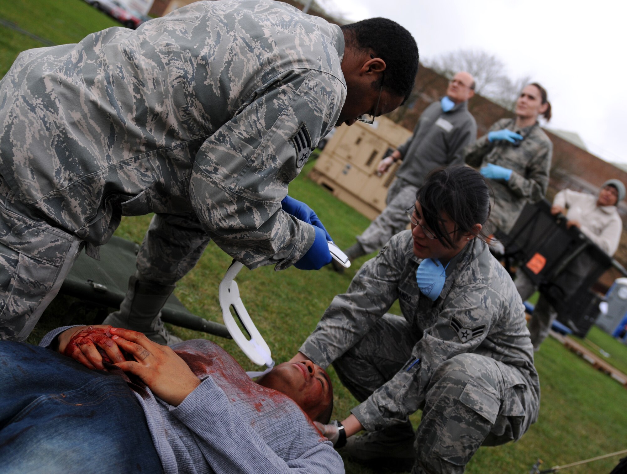 ROYAL AIR FORCE FELTWELL, England – Senior Airman Errington Neysmith, 48th Medical Operations Squadron aerospace medical technician, and Airman 1st Class Michelle Hernando, 48th MDOS medical technician, secure a patient during a mass casualty excerise, Dec. 8, 2011. The 48th Medical Group hosted a week-long mobile Expeditionary Medical Support course at RAF Feltwell to keep their readiness capabilities sharp in a mock-deployed environment. (U.S. Air Force photo by Airman 1st Class Cory D. Payne)