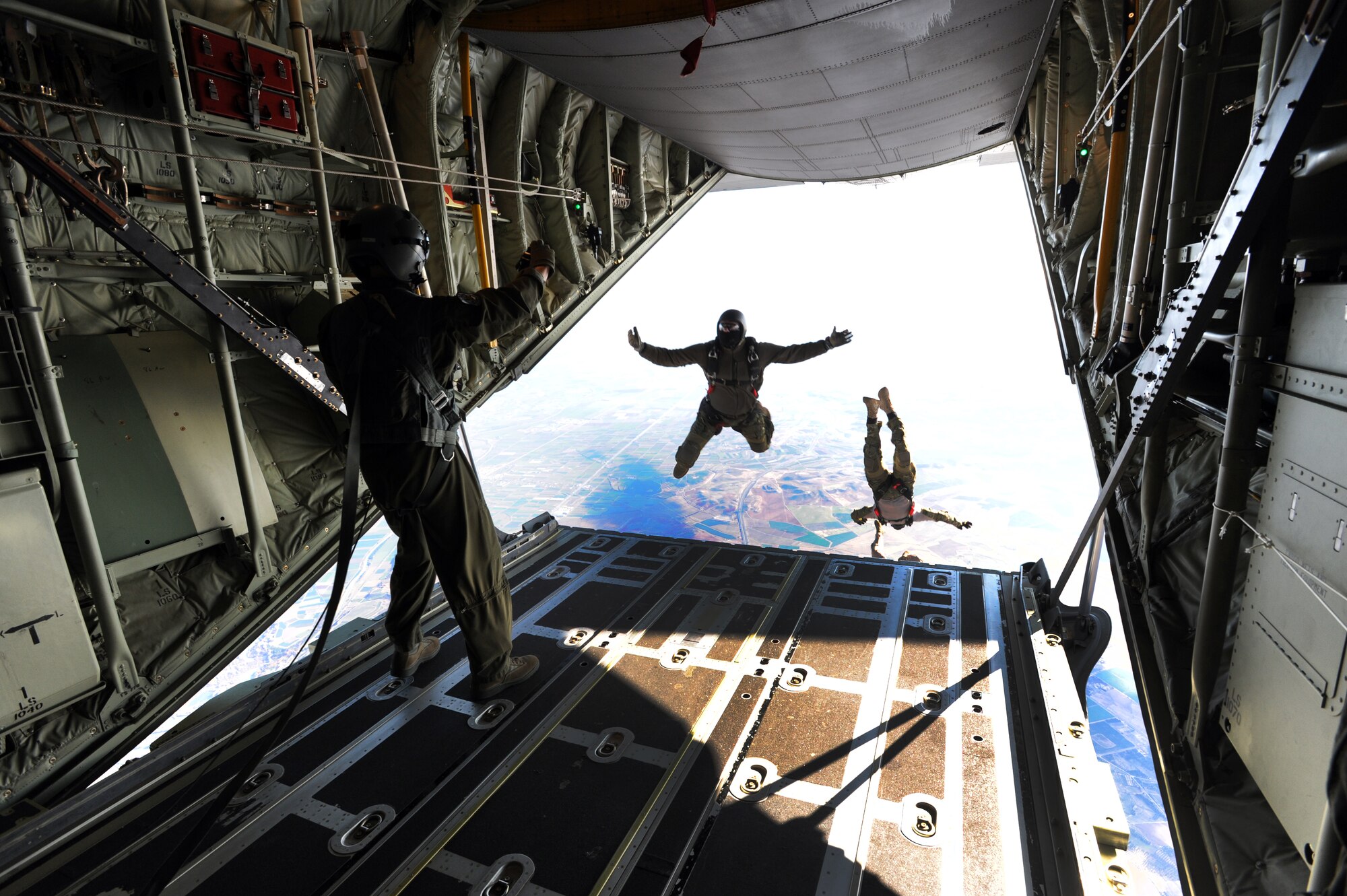 Air Force members parachute out of a C-130J Super Hercules during an off-station training in Zaragoza, Spain., Dec. 12, 2011. The OST consisted of a 90 member team and two aircraft, all assembled to enhance interoperability between U.S. and Spanish air forces as well as build partnerships between the two countries. . (U.S. Air Force photo by Airman 1st Class Caitlin O'Neil-McKeown)