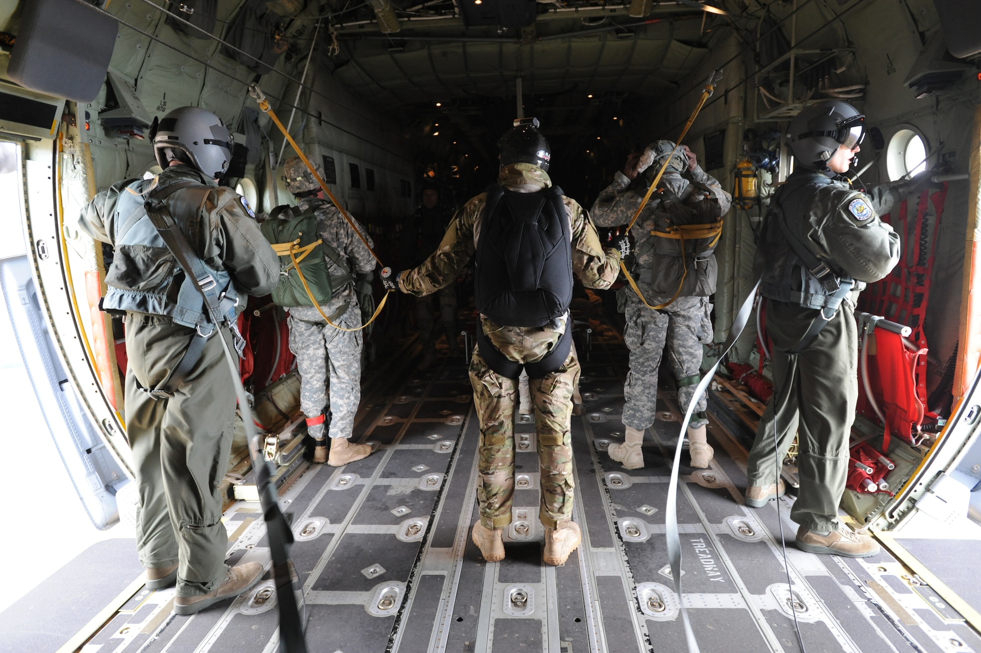 Members of diffrent military branches brace thenselves while inside an C-130J Super Hercules  during an off-station training in Zaragoza, Spain., Dec. 12, 2011. The OST consisted of a 90 member team and two aircraft, all assembled to enhance interoperability between U.S. and Spanish air forces as well as build partnerships between the two countries. (U.S. Air Force photo by Airman 1st Class Caitlin O'Neil-McKeown)