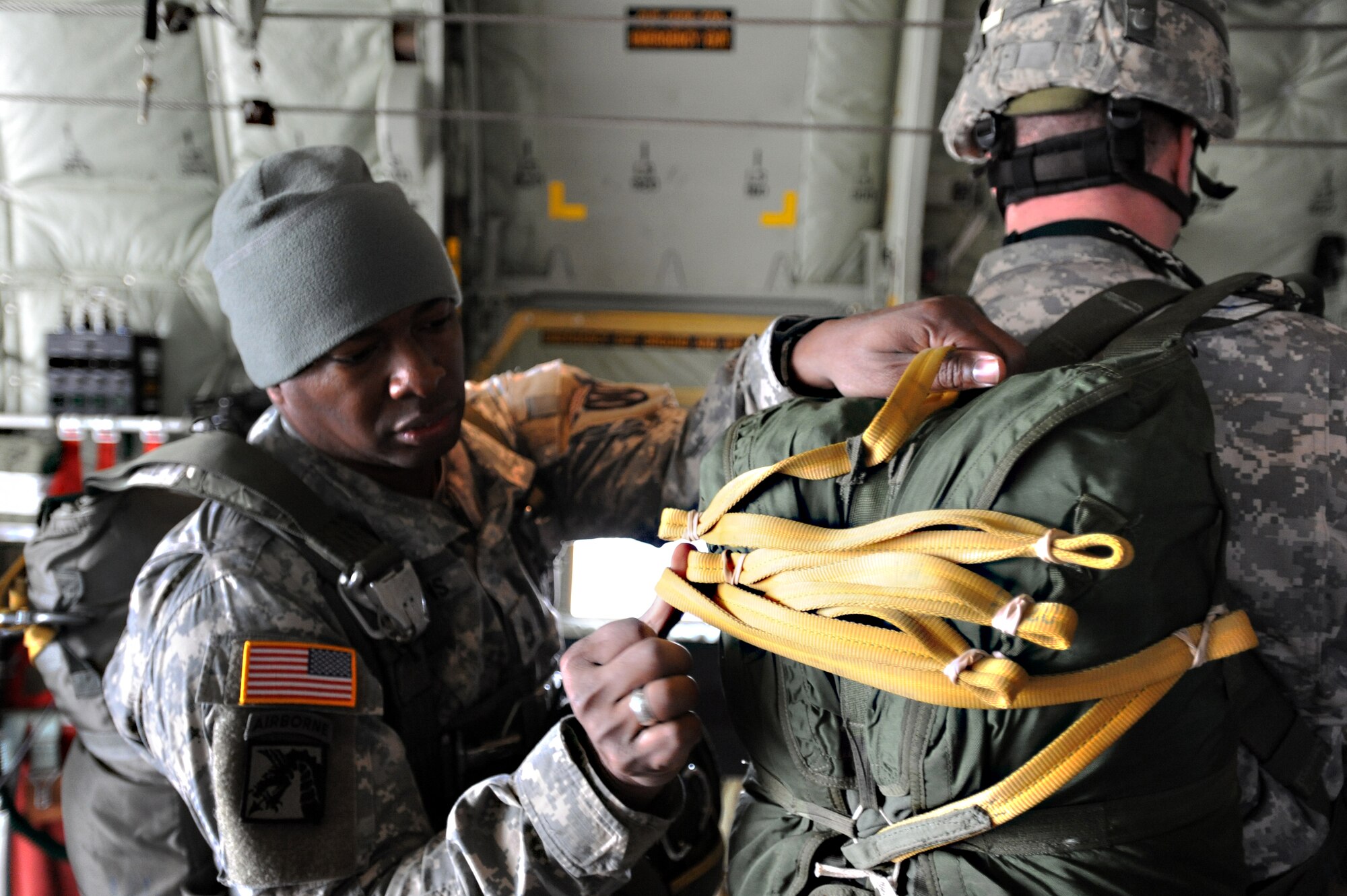 Army Sgt. 1st Class Herschel L. Gillins, 5th Quarter Master from Rine Ordanance Barracks, secures another  paratroopers flight equipment during an off-station training in Zaragoza, Spain., Dec. 12, 2011. The OST consisted of a 90 member team and two aircraft, all assembled to enhance interoperability between U.S. and Spanish air forces as well as build partnerships between the two countries. (U.S. Air Force photo by Airman 1st Class Caitlin O'Neil-McKeown)