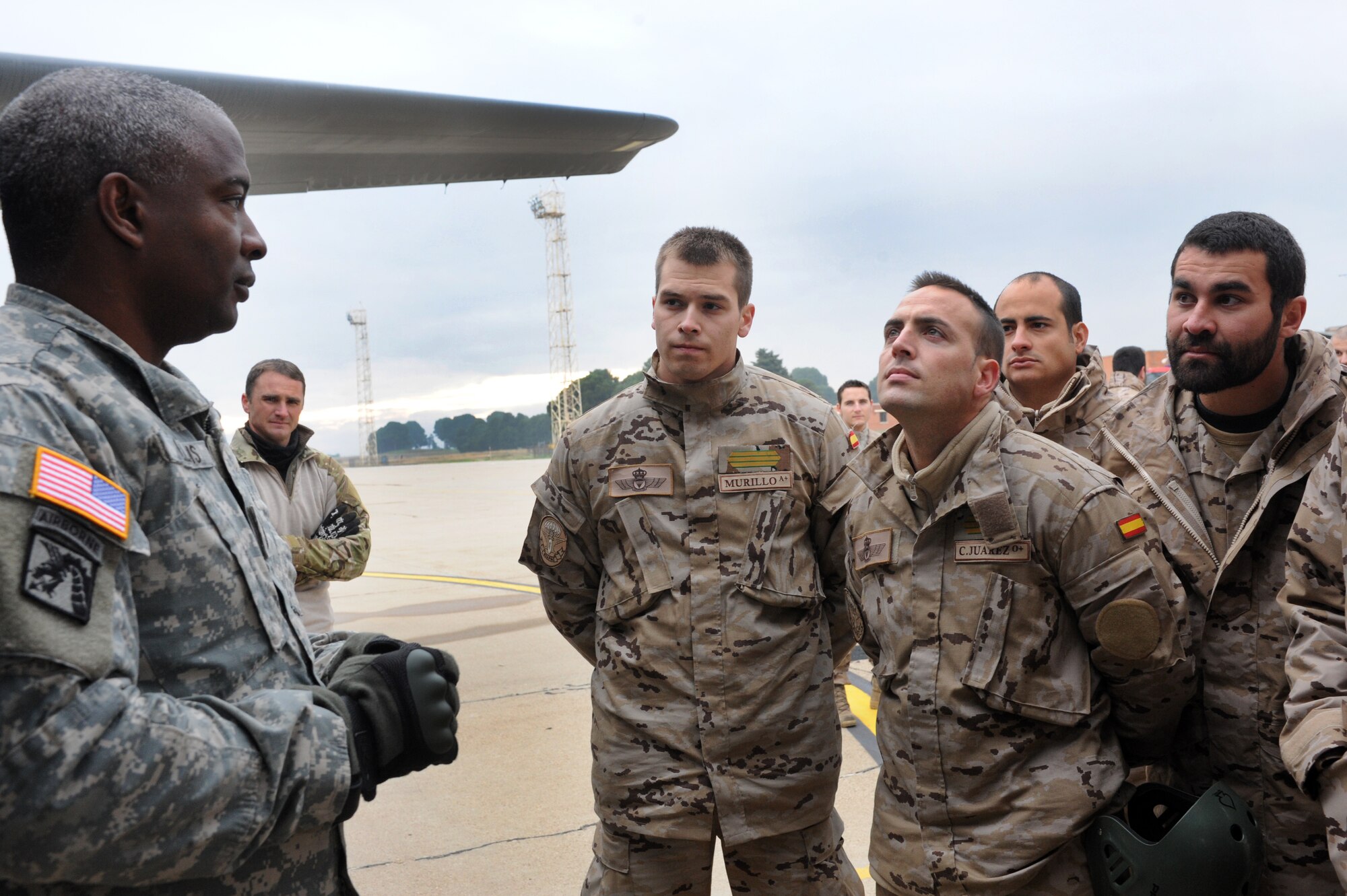 Army Sgt. 1st Class Herschel L. Gillins, 5th Quarter Master from Rine Ordanance Barracks,  conducts a preboarding brief for members of the Spanish air force during an off-station training in Zaragoza, Spain., Dec. 12, 2011. The OST consisted of a 90 member team and two aircraft, all assembled to enhance interoperability between U.S. and Spanish air forces as well as build partnerships between the two countries. (U.S. Air Force photo by Airman 1st Class Caitlin O'Neil-McKeown)