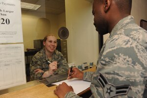 Staff Sgt. Vickie Erickson, 366th Comptroller Squadron noncommissioned officer-in-charge of customer service, assists a customer June 16, 2011, from inside the vault at Mountain Home Air Force Base, Idaho. The MHAFB finance office was recently awarded four Air Combat Command awards to include: the Major General Alfred K. Flowers comptroller organization of the year, financial analysis office of the year and financial services office of the year and the financial management civilian of the year. (U.S. Air Force photo by Senior Airman Debbie Lockhart)
