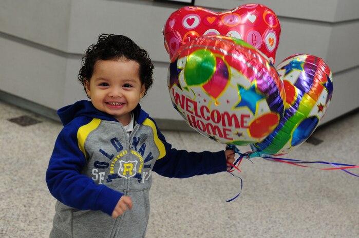 Daniel Diaz holds welcome home balloons while waiting for his mother, Staff Sgt. Karen Cruz to return from a 120- day deployment to Southwest Asia at Joint Base Charleston - Air Base Nov. 5. Airmen must have an up-to-date and accurate Family Care Plan to ensure their children are cared for during deployments. (U.S. Air Force photo/ Staff Sgt. Nicole Mickle 