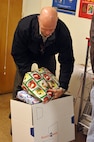 Tim Lemley, Air Force Personnel Center data base administrator, boxes Christmas gifts to be shipped out at the Joint Base San Antonio-Randolph Post Office for the holidays Dec. 8. (U.S. Air Force photo/Airman 1st Class Alexis Siekert)
