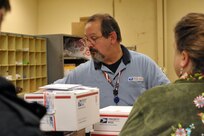 Jeff Sanna, United States Postal Services sales and services associate, readies packages to be shipped out at the Joint Base San Antonio-Randolph Post Office for the holidays Dec. 8. (U.S. Air Force photo/Airman 1st Class Alexis Siekert)
