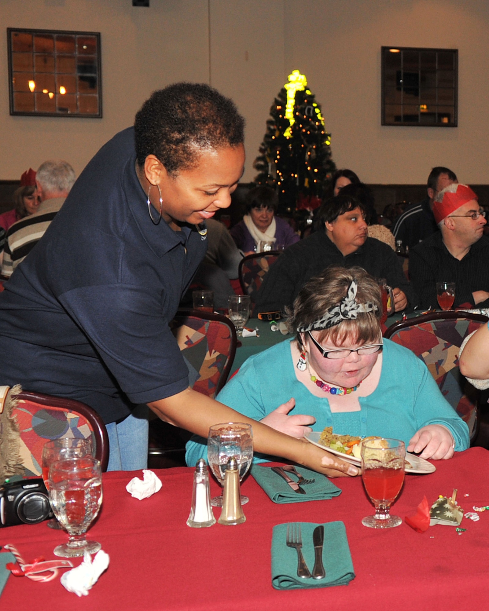 RAF MILDENHALL, England - Chief Master Sgt. Vernitia Johnson, 100th Logistics Readiness Squadron, serves food at the Air Force Sergeants Association Special Persons Luncheon at the Galaxy Club here Dec. 10, 2011. The afternoon of activities included lunch, photos with Santa, dancing and Christmas gifts. (U.S. Air Force photo/Senior Airman Jerilyn Quintanilla)