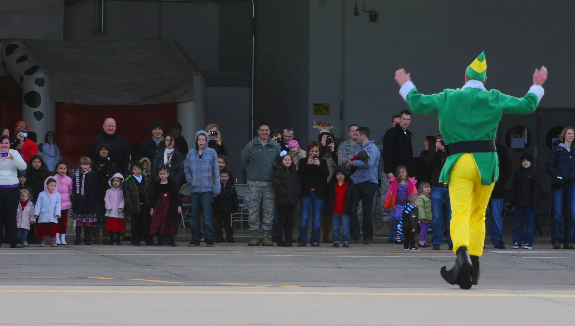 RAF MILDENHALL, England -- An elf announces the arrival of Santa Claus here Dec. 10, 2011 outside Hanger 803.  Santa, his elves and Rudolph arrived in a KC-135 Statotanker to visit with children from RAF Mildenhall during a children’s holiday party. (U.S. Air Force photo/ Staff Sgt. Tabitha M. Lee) 