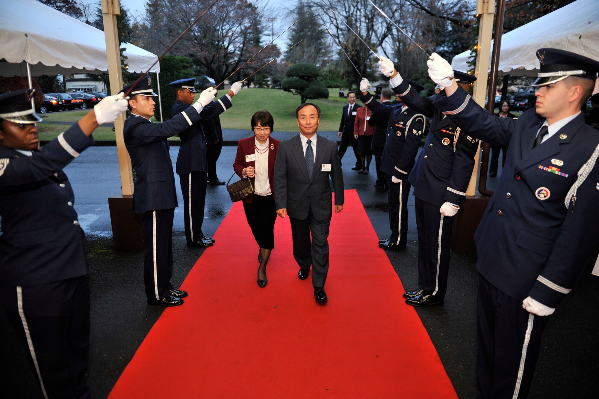 YOKOTA AIR BASE, Japan -- Japan Air Self-Defense Force Lt. Gen. Kiyoshi Yada, Air Support Command commander, enters through a saber cordon into the house of Lt. Gen. Burton Field, U.S. Forces, Japan, and 5th Air Force commander, at Yokota Air Base, Japan, Dec. 3, 2011. Field held a holiday open house with U.S. and Japanese dignitaries to bolster bilateral relations with Japan. (U.S. Air Force photo/Staff Sgt. Samuel Morse)