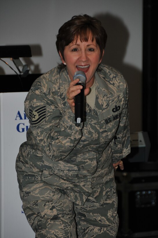 TSgt Erin McPherson is all smiles as she performs during a "Combat Dinner" with the 562nd Air Force Band in support of Lt. Gen. Harry M. Wyatt III, director of the Air National Guard, who hosted Business and Industry Days events at the Air Guard's international F-16 training unit in Tucson, Az.
