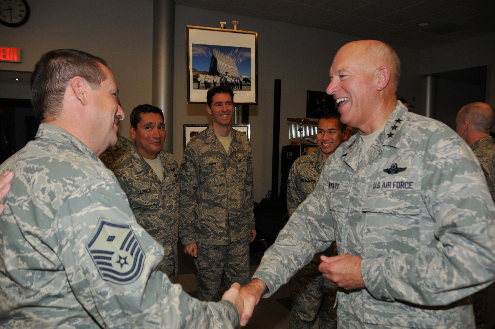 Lt. Gen. Harry M. Wyatt III, director of the Air National Guard, presents Command Coins to members of the 562nd Air Force Band for supporting Business and Industry Days events at the Air Guard's international F-16 training unit.