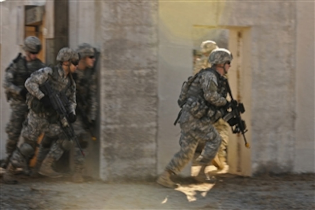 Army paratroopers carry out a combined arms maneuver during a live fire exercise at Fort Bragg, N.C., on Dec. 5, 2011.  The paratroopers are assigned to the 82nd Airborne Division's 2nd Battalion, 505th Parachute Infantry Regiment, 3rd Brigade Combat Team.  The exercise was conducted to ensure that the unit is adequately prepared to deploy on any mission around the world in the event that the global ready force is requested.  