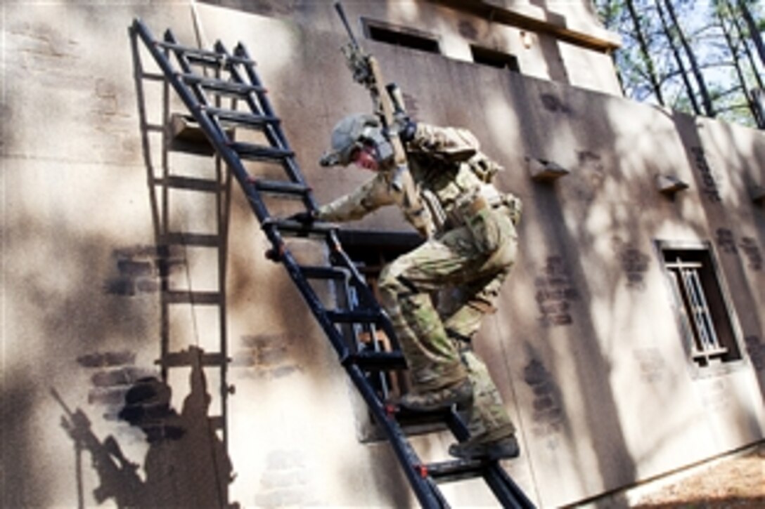 A soldier climbs down a ladder to get to his next firing location during the annual U.S. Army Special Operations Command Sniper Competition on Fort Bragg, N.C., Dec. 8, 2011. The competition, organized for the third year by members of Delta Company, 2nd Battalion, 1st Special Warfare Training Group, tested the skills of 32 teams of military and civilian law enforcement snipers.