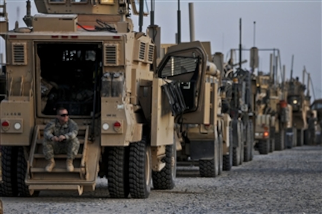 A U.S. Army soldier with the 82nd Airborne Division surveys the area from the dropdown stairs of his mine-resistant, ambush-protected vehicle while crossing the Khabari border from Iraq into Kuwait on Dec. 9, 2011.  